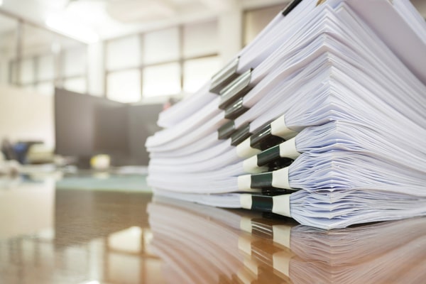 stack of packets of papers on a desk